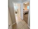 Hallway view into bathroom and bedroom showcasing a neutral color scheme and tile floors at 8340 Winterchase Pl, Las Vegas, NV 89143