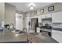 Updated kitchen featuring stainless appliances, tile backsplash, and modern countertops at 8501 W University Ave # 1083, Las Vegas, NV 89147