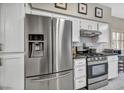 Modern kitchen boasts stainless steel appliances, white cabinets, and sleek countertops at 8501 W University Ave # 1083, Las Vegas, NV 89147
