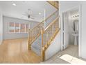 Bright entryway showcasing a staircase, bathroom, and wood laminate flooring at 9021 Last Hope Ave, Las Vegas, NV 89178