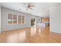 Open-concept living room featuring wood laminate floors and abundant natural light at 9021 Last Hope Ave, Las Vegas, NV 89178
