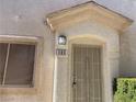 Close-up of the front door entrance with a security screen and the house number clearly displayed at 9333 Leaping Deer Pl # 103, Las Vegas, NV 89178