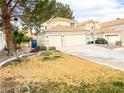 Inviting two-story home features a three-car garage and a cozy front yard at 9552 Wooden Pier Way, Las Vegas, NV 89117