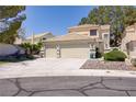 Charming front exterior featuring a spacious two-car garage, manicured shrubs, and a tile roof at 9552 Wooden Pier Way, Las Vegas, NV 89117