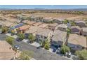 An aerial view of a well-planned neighborhood with desert landscaping and mountain views at 9872 Chief Sky St, Las Vegas, NV 89178