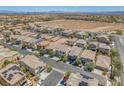 An aerial view showcasing the community and the surrounding landscape with mountains in the distance at 9872 Chief Sky St, Las Vegas, NV 89178