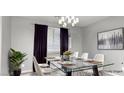 Dining room with a glass-top table, seating for six, and elegant lighting at 1015 Solana Crest St, Henderson, NV 89052