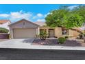 Inviting single-story home featuring a two-car garage, desert landscaping, and a welcoming front entrance at 10532 Sea Palms Ave, Las Vegas, NV 89134