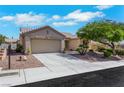 Attractive single-story home with a two-car garage, neat desert landscaping, and a paved driveway at 10532 Sea Palms Ave, Las Vegas, NV 89134