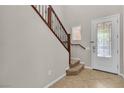 Bright entryway featuring tile floors, staircase with wooden banister, and a decorative glass front door at 11014 Great Sioux Rd, Las Vegas, NV 89179