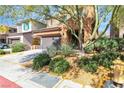 Charming two-story home with a well-maintained lawn, mature trees, and a 'for sale' sign at 11014 Great Sioux Rd, Las Vegas, NV 89179