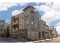 Modern apartment building exterior with gray tones, private garages, and street parking at 11256 Rainbow Peak Ave # 202, Las Vegas, NV 89135