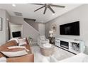 Open living room area featuring a large TV and a modern electric fireplace at 11256 Rainbow Peak Ave # 202, Las Vegas, NV 89135