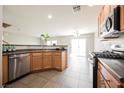 Well-equipped kitchen with stainless steel appliances, modern fixtures, and convenient access to the dining area at 1180 Via Vinci, Henderson, NV 89052