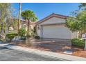 Inviting single-story home boasts a two-car garage and beautifully landscaped front yard at 151 Cliff Valley Dr, Las Vegas, NV 89148