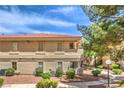Side view of an apartment home with well-maintained landscaping and mature trees providing ample shade at 1557 Lake Placid Ter # 1557, Henderson, NV 89014