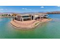 Waterfront property with sleek architecture, nestled on an island with breathtaking views of the lake and mountains at 1600 Pleasant Bay Ct, Henderson, NV 89011