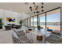 Dining area features modern lighting fixture, fireplace and sliding glass doors that bring in plenty of natural light at 1600 Pleasant Bay Ct, Henderson, NV 89011