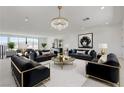 Spacious living room with modern decor, plush seating, and ample natural light at 1600 Pleasant Bay Ct, Henderson, NV 89011