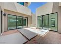 Contemporary patio with a view into the modern home's interior through sliding glass doors at 1600 Pleasant Bay Ct, Henderson, NV 89011