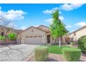 Charming single-story home boasts a two-car garage and a beautifully landscaped front yard with mature trees at 177 Rocky Star St, Henderson, NV 89012