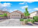 Attractive single-story home featuring a two-car garage, manicured lawn, and a welcoming front entrance at 177 Rocky Star St, Henderson, NV 89012