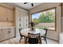Charming dining area with a large window offering serene views of the backyard, creating a perfect ambiance at 2074 Sutton Way, Henderson, NV 89074