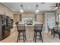 Modern kitchen features a stylish island with bar seating, stainless steel appliances, and bright, updated countertops at 2074 Sutton Way, Henderson, NV 89074