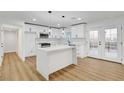 Modern kitchen featuring white cabinetry, a large quartz countertop island, stainless steel appliances, and French doors at 2521 Richfield Blvd, Las Vegas, NV 89102