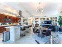 Modern kitchen with a large island, stainless steel appliances, and seating, flowing into a dining and living area at 2747 Paradise Rd # 206, Las Vegas, NV 89109
