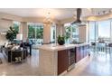 Open-concept living area with a stylish kitchen island, comfortable seating, and expansive windows offering ample natural light at 2747 Paradise Rd # 206, Las Vegas, NV 89109