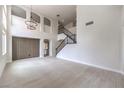 Large living room with vaulted ceilings, arched doorways, with staircase to the upper level at 3065 Blue Monaco St, Las Vegas, NV 89117