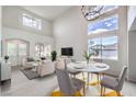 Spacious living room with high ceilings, ample seating, and lots of natural light from large windows at 3065 Blue Monaco St, Las Vegas, NV 89117