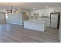 Open floor plan showcasing the kitchen and living room with modern lighting at 3219 Bluebird St, Las Vegas, NV 89121