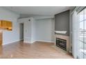 Open-concept living room features wood floors, fireplace, and sliding glass doors at 3318 N Decatur Blvd # 2110, Las Vegas, NV 89130