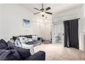 Cozy living room featuring neutral carpet and a ceiling fan for added comfort at 3515 Cactus Shadow St # 104, Las Vegas, NV 89129