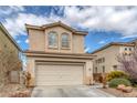 View of a two-story home with a two-car garage, desert landscaping, and a concrete driveway at 3964 Irvin Ave, Las Vegas, NV 89141