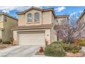 Two-story home with an attached two-car garage and mature landscaping in a desert environment at 3964 Irvin Ave, Las Vegas, NV 89141