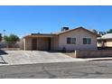This single-story house has a covered carport with two large windows on the side of the house at 4748 Terra Linda Ave, Las Vegas, NV 89120