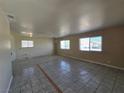 Spacious living room with tile floors, ample natural light, and neutral walls ready for customization at 4748 Terra Linda Ave, Las Vegas, NV 89120