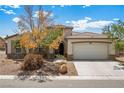 Charming single-story home features manicured landscaping and a spacious two-car garage at 565 Mazelle Ln, Pahrump, NV 89060