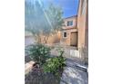 A charming front yard with lush greenery and a small, decorative fence at 6545 Netherseal Ave, Las Vegas, NV 89139