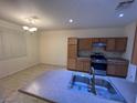 A well-lit kitchen with stainless steel appliances and granite countertops offers a functional and stylish cooking space at 6545 Netherseal Ave, Las Vegas, NV 89139