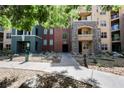 Exterior view of building 68, with stone accents, lush landscaping and pathway to front door at 68 E Serene Ave # 224, Las Vegas, NV 89123