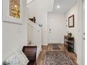Inviting entryway with a staircase, bench, decorative rug, and a console table, creating a warm welcome at 6848 Sunflower Fields St, North Las Vegas, NV 89086