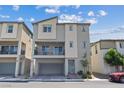 Stylish two-story home featuring a balcony, neutral colors, an attached garage, and a charming wreath on the front door at 6848 Sunflower Fields St, North Las Vegas, NV 89086