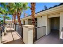 Exterior view of condo complex featuring pedestrian walkway, desert landscaping, and sunny skies in a desert climate at 7173 S Durango Dr # 307, Las Vegas, NV 89113