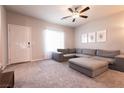 Spacious living room featuring neutral walls, plush carpet, and a large sectional sofa at 7302 Sunray Point St, North Las Vegas, NV 89084