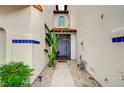 Inviting entryway with gravel landscaping and tropical plants for a serene welcome at 8719 Villa Ariel Ln, Las Vegas, NV 89147