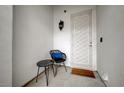 Cozy front porch with stylish seating arrangement and decorative door at 8719 Villa Ariel Ln, Las Vegas, NV 89147
